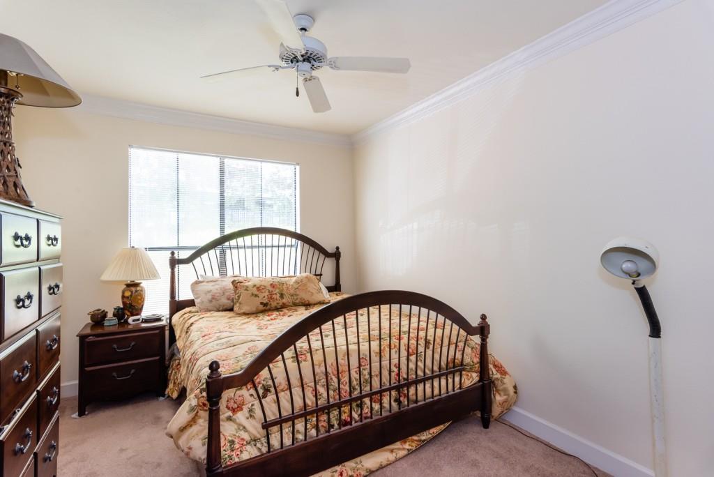 3777 Peachtree Road Northeast, Unit 1007 Brookhaven, GA 30319 - Photo 20 of 39 a bedroom with a bed and a chandelier