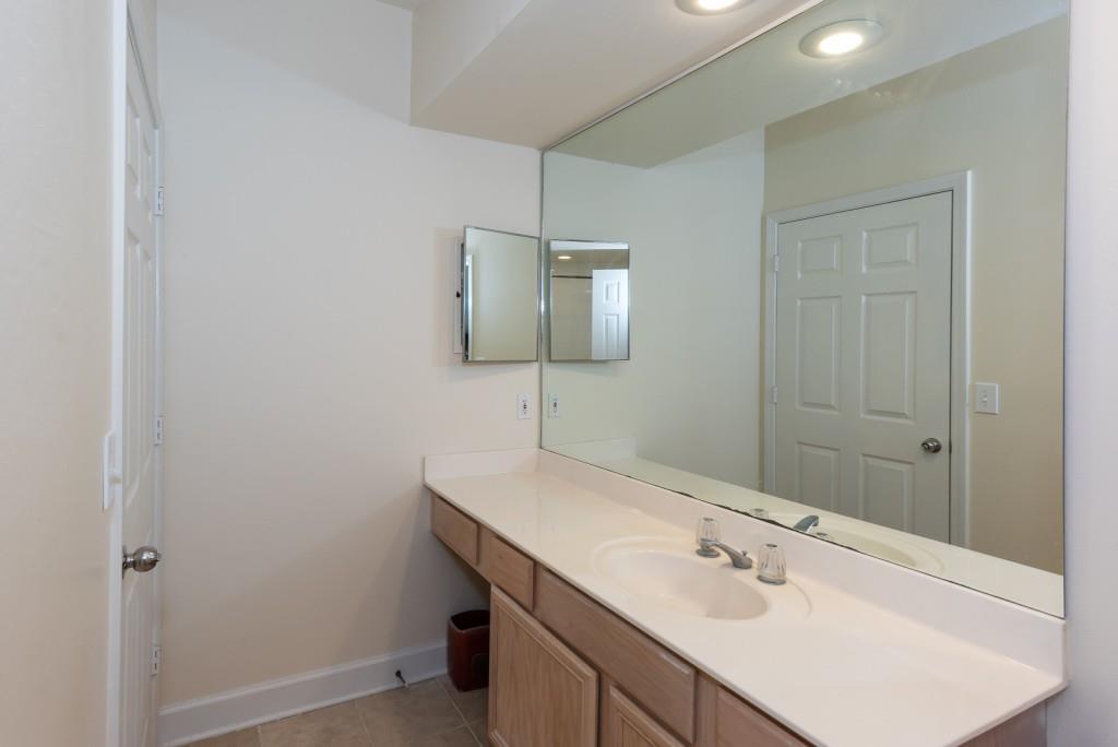 3777 Peachtree Road Northeast, Unit 1007 Brookhaven, GA 30319 - Photo 22 of 39 a bathroom with a sink and a mirror