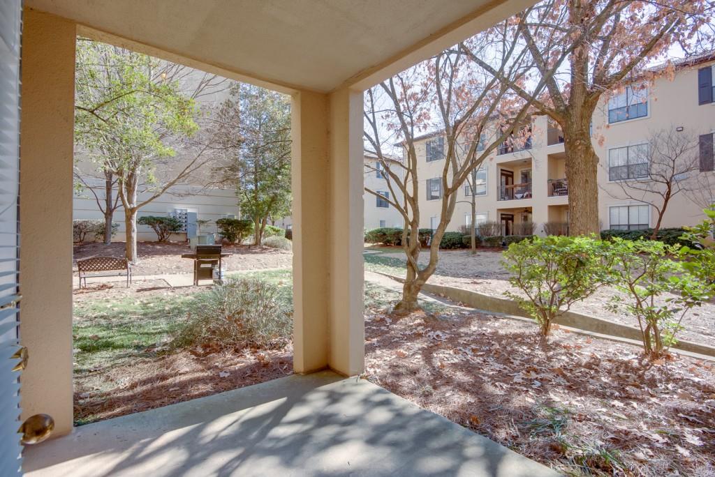 3777 Peachtree Road Northeast, Unit 1007 Brookhaven, GA 30319 - Photo 25 of 39 a view of a porch with chairs and a yard