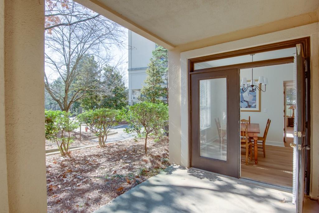 3777 Peachtree Road Northeast, Unit 1007 Brookhaven, GA 30319 - Photo 26 of 39 a view of a porch with chairs and backyard of the house