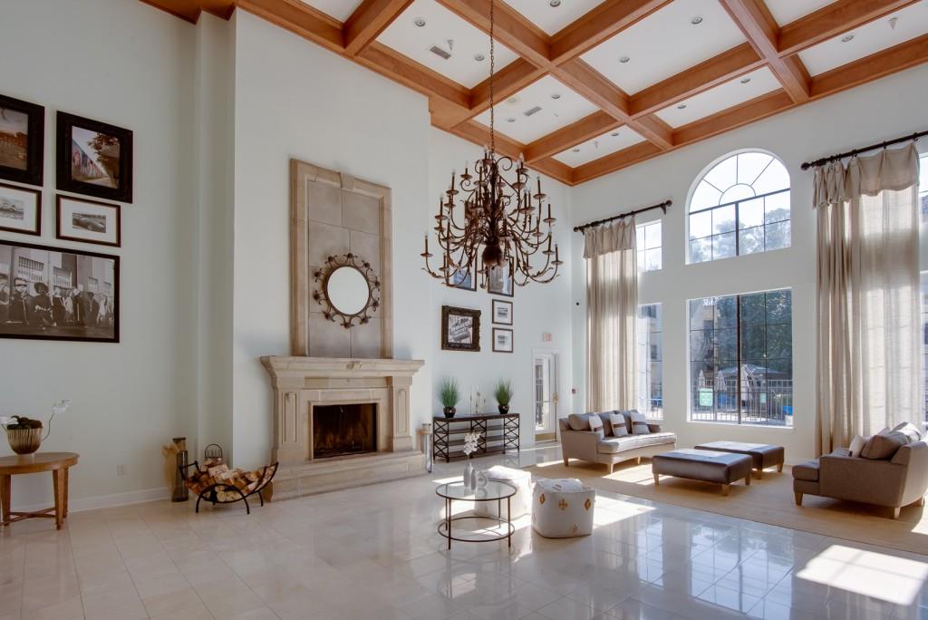3777 Peachtree Road Northeast, Unit 1007 Brookhaven, GA 30319 - Photo 30 of 39 a living room with furniture a fireplace and a chandelier