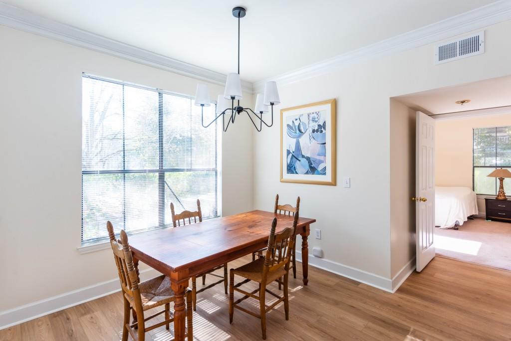 3777 Peachtree Road Northeast, Unit 1007 Brookhaven, GA 30319 - Photo 6 of 39 a view of a dining room with furniture window and wooden floor