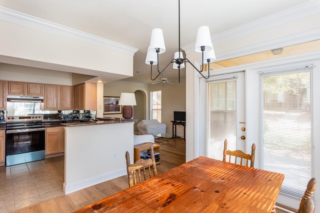 3777 Peachtree Road Northeast, Unit 1007 Brookhaven, GA 30319 - Photo 8 of 39 a bedroom with a bed a chandelier and flat screen tv