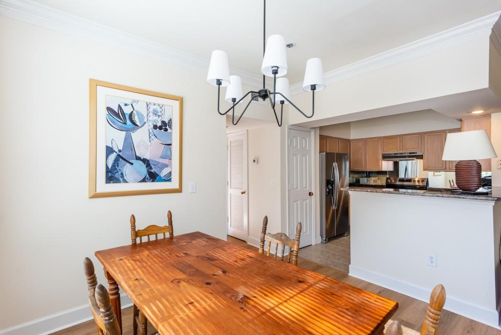 3777 Peachtree Road Northeast, Unit 1007 Brookhaven, GA 30319 - Photo 9 of 39 a bedroom with a bed and a chandelier