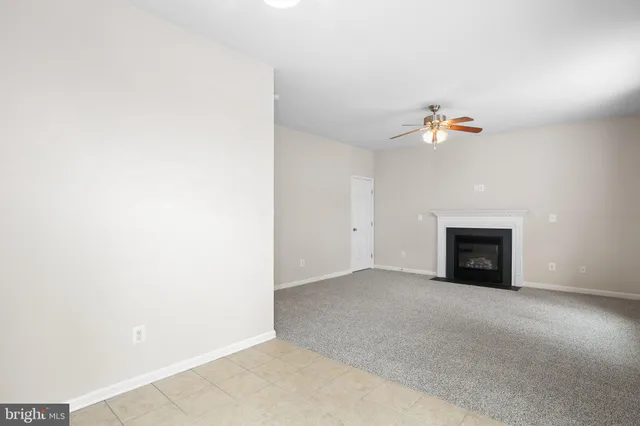 a view of an empty room with a fireplace
