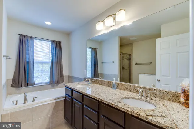 a bathroom with a tub and a sink