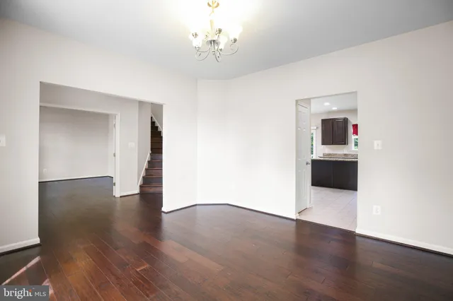 a view of a room with wooden floor and an empty space