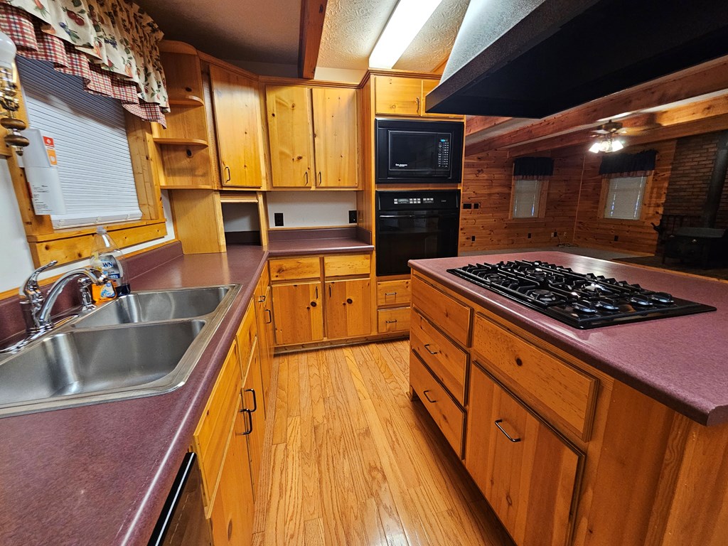 1705 Homer Wright Road Talking Rock, GA 30175 - Photo 22 of 98 a kitchen with stainless steel appliances granite countertop a sink stove and refrigerator