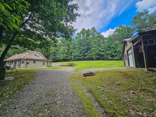 1705 Homer Wright Road Talking Rock, GA 30175 - Photo 37 of 98 a view of a house with a yard and a large tree
