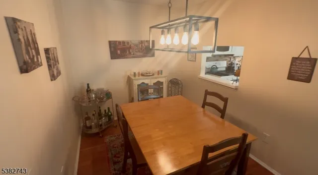 a room with a table chairs and appliances