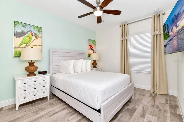a living room with furniture a kitchen view and a fireplace