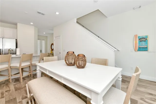 a kitchen with a table chairs and a dining table