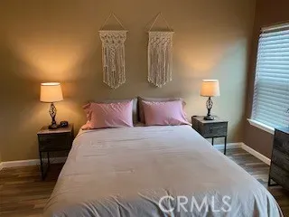 a bedroom with a bed and a night stand