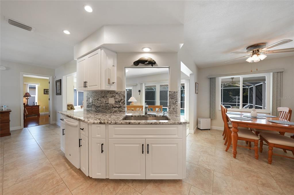 18097 Brazil Avenue Port Charlotte, FL 33948 - Photo 12 of 37 a view of living room with granite countertop furniture and a fireplace