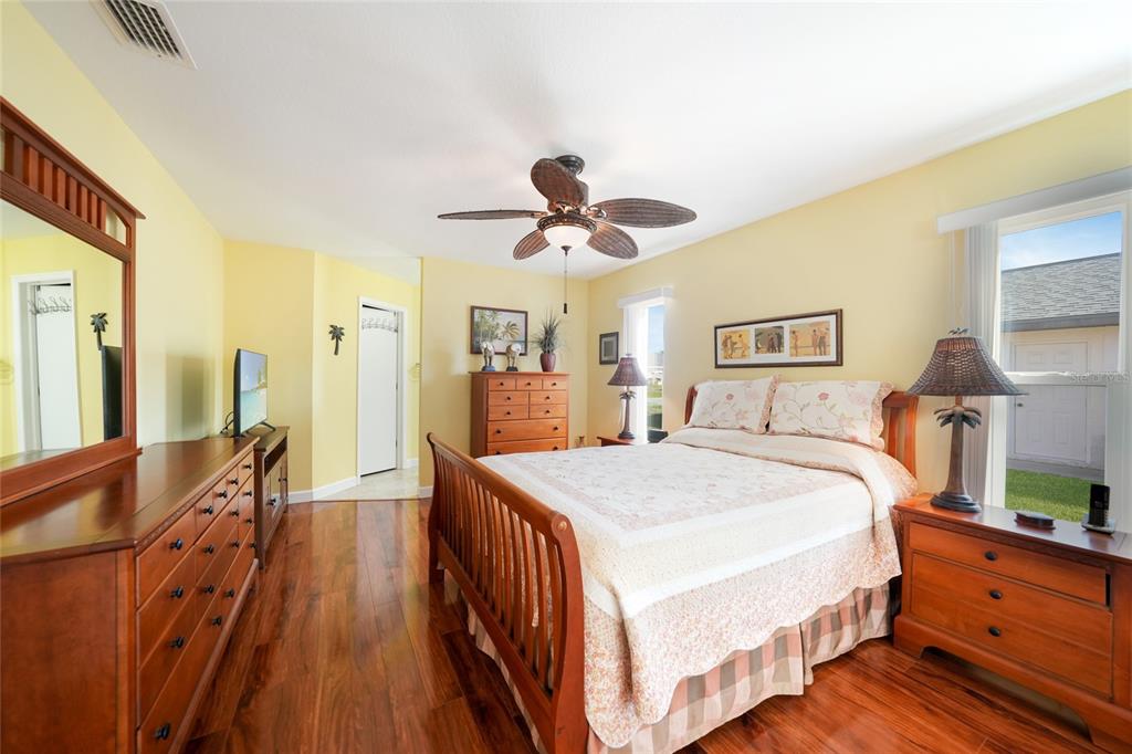 18097 Brazil Avenue Port Charlotte, FL 33948 - Photo 17 of 37 a spacious bedroom with a bed and a chandelier