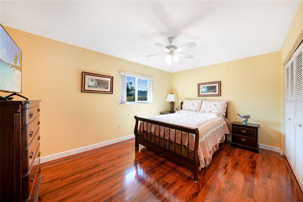 18097 Brazil Avenue Port Charlotte, FL 33948 - Photo 21 of 37 a bedroom with a bed chandelier and a window