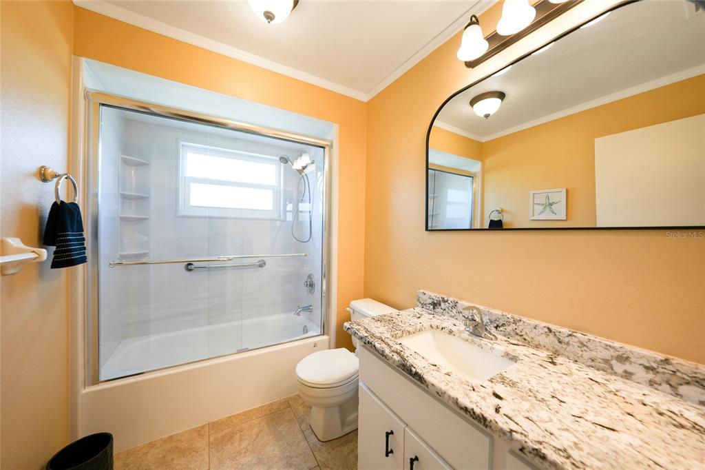 18097 Brazil Avenue Port Charlotte, FL 33948 - Photo 23 of 37 a bathroom with a granite countertop sink toilet and shower