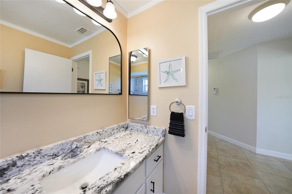 18097 Brazil Avenue Port Charlotte, FL 33948 - Photo 24 of 37 a bathroom with a sink and mirror