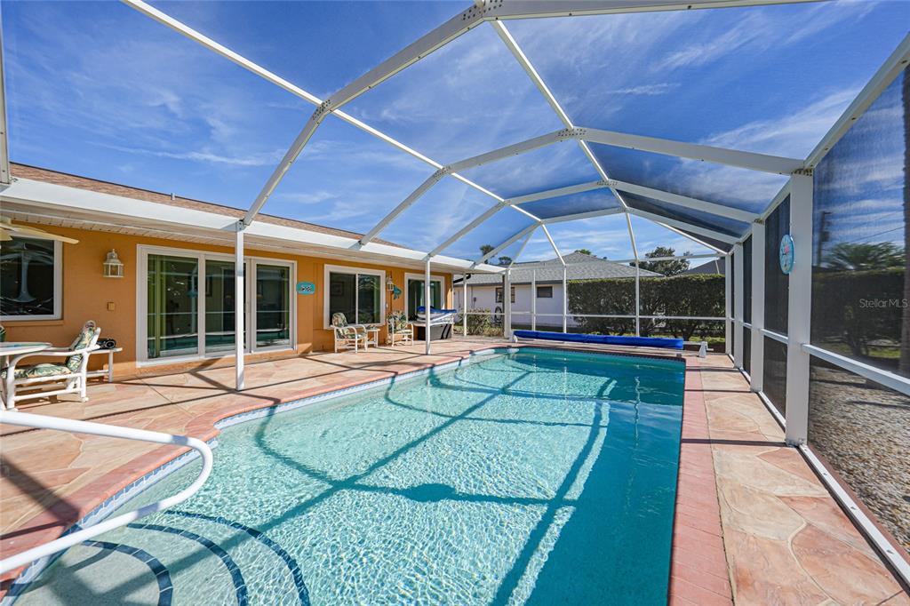 18097 Brazil Avenue Port Charlotte, FL 33948 - Photo 27 of 37 a view of a backyard with sitting area and a garden