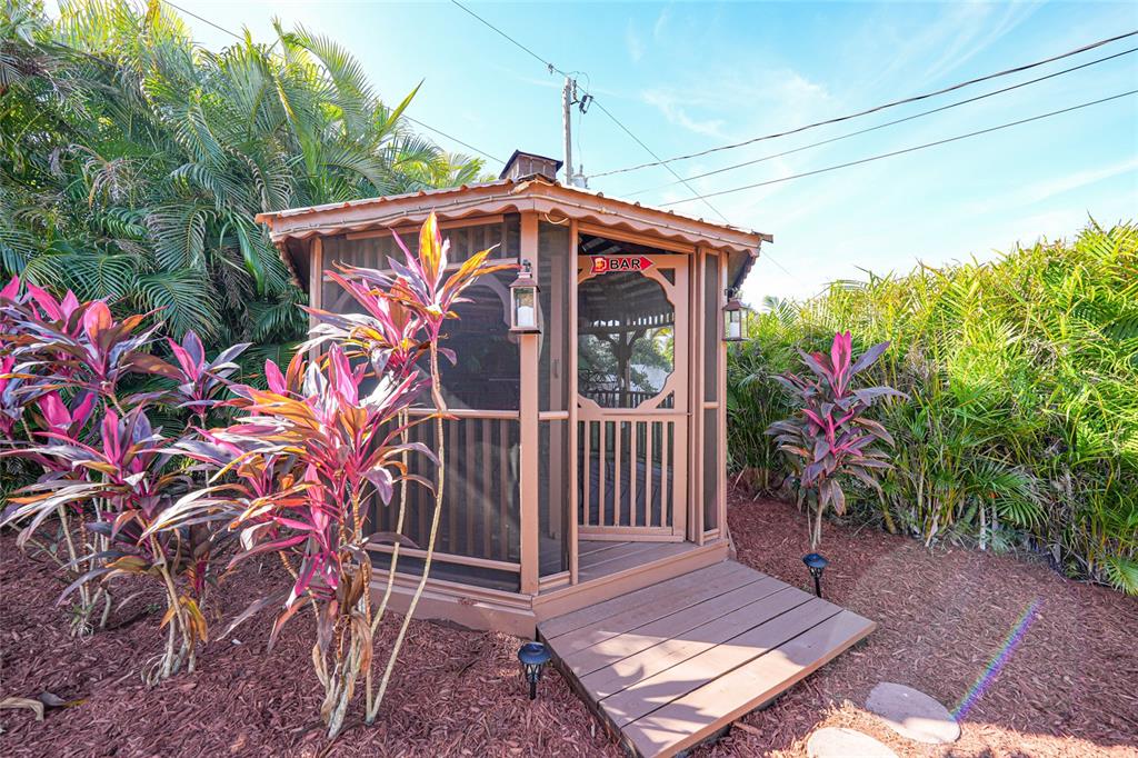 18097 Brazil Avenue Port Charlotte, FL 33948 - Photo 32 of 37 a view of a house with a small yard and wooden floor