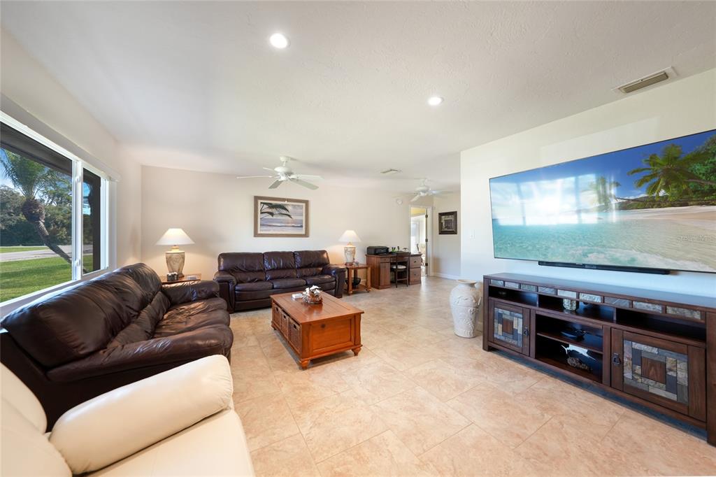 18097 Brazil Avenue Port Charlotte, FL 33948 - Photo 6 of 37 a living room with furniture and a flat screen tv