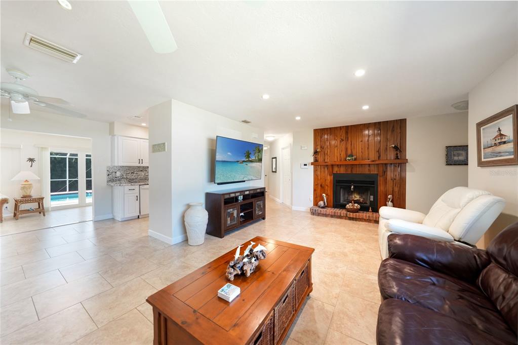 18097 Brazil Avenue Port Charlotte, FL 33948 - Photo 7 of 37 a living room with furniture and a fireplace