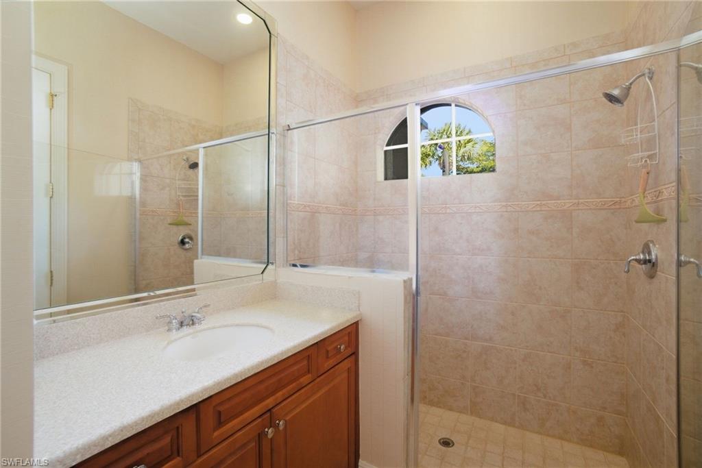 17015 Porta Vecchio Way, Unit 101 Naples, FL 34110 - Photo 18 of 39 a bathroom with a sink and a mirror