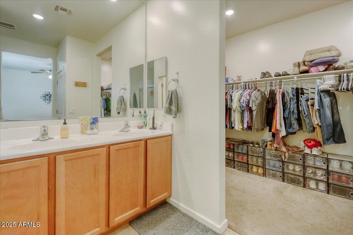 9825 West Trumbull Road Tolleson, AZ 85353 - Photo 11 of 19 a bathroom with a sink and a mirror