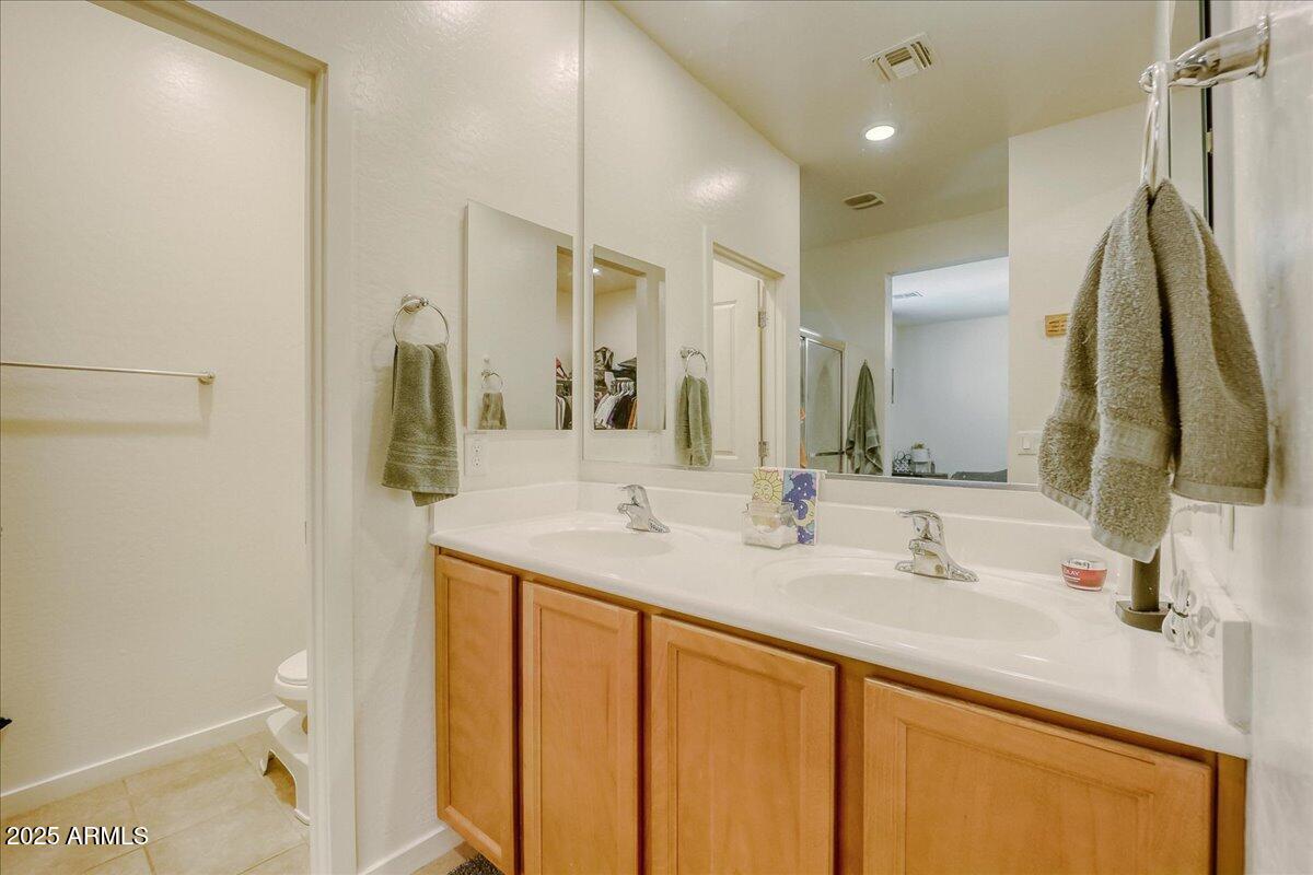 9825 West Trumbull Road Tolleson, AZ 85353 - Photo 13 of 19 a bathroom with a sink and a mirror