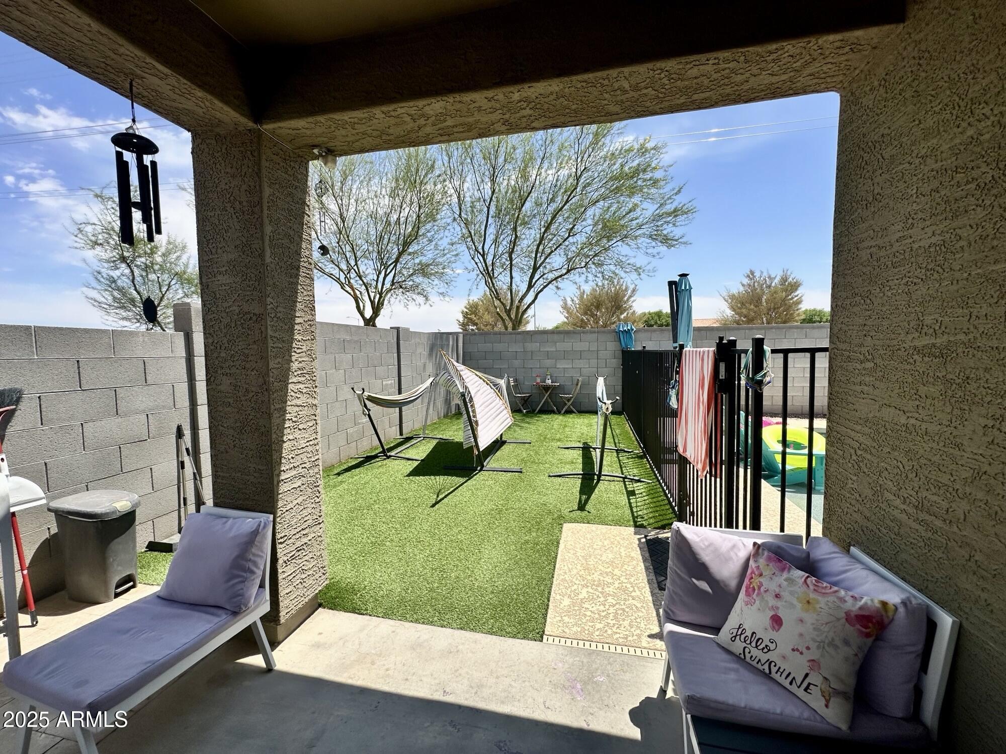 9825 West Trumbull Road Tolleson, AZ 85353 - Photo 18 of 19 a view of backyard with outdoor seating and a patio