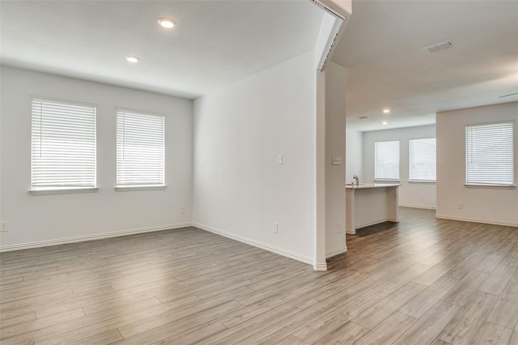 134 Blair Drive Fate, TX 75189 - Photo 11 of 25 an empty room with wooden floor and windows
