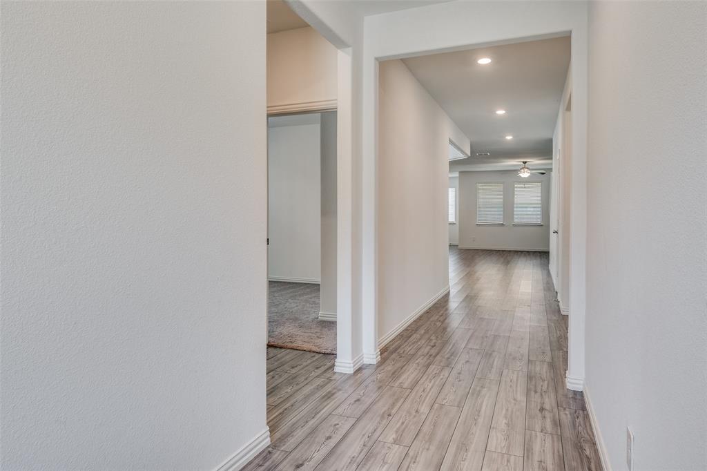 134 Blair Drive Fate, TX 75189 - Photo 12 of 25 a view of a hallway with wooden floor