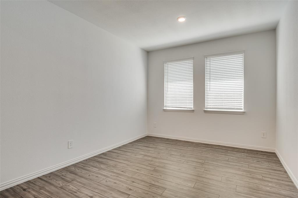 134 Blair Drive Fate, TX 75189 - Photo 13 of 25 wooden floor in an empty room with a window