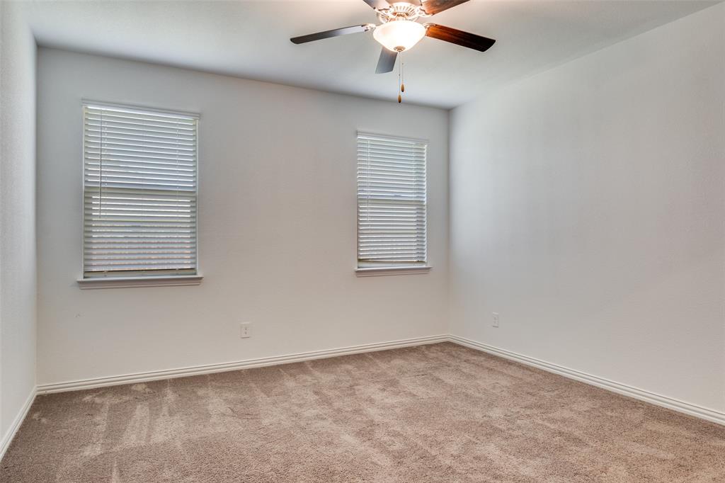 134 Blair Drive Fate, TX 75189 - Photo 14 of 25 an empty room with windows and fan