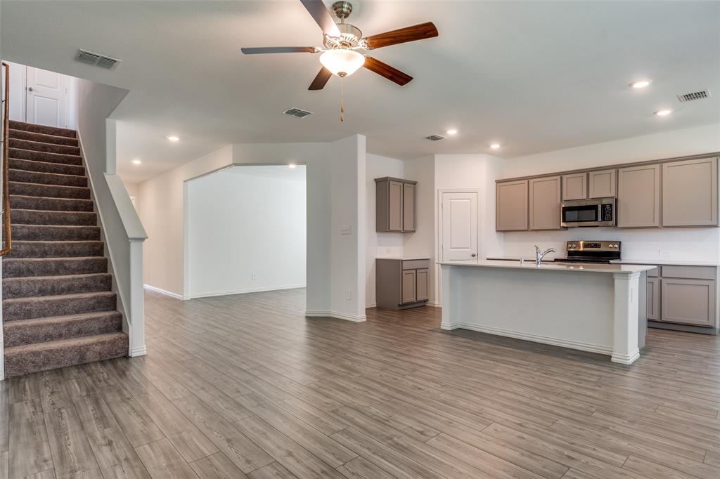 134 Blair Drive Fate, TX 75189 - Photo 3 of 25 a view of kitchen with refrigerator microwave and stove top oven