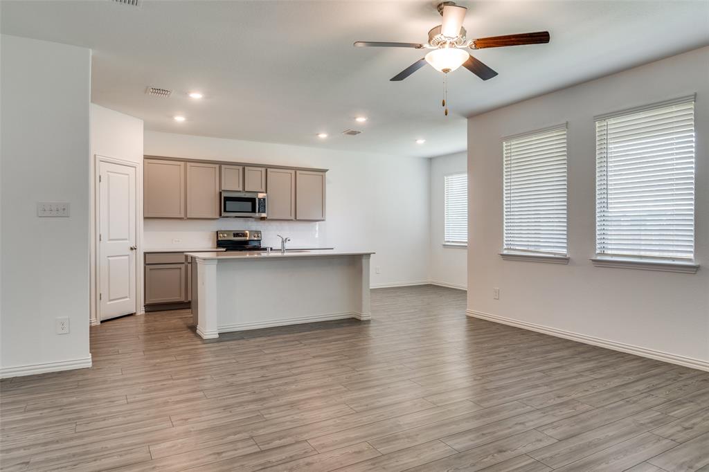 134 Blair Drive Fate, TX 75189 - Photo 5 of 25 a view of kitchen with granite countertop cabinets and wooden floor