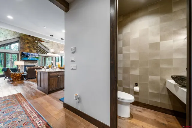 a bathroom with a sink a toilet and shower