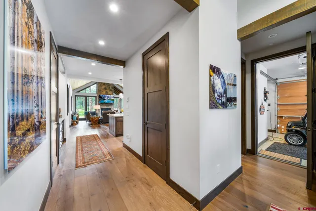 a view of a hallway view with living room filled with furniture