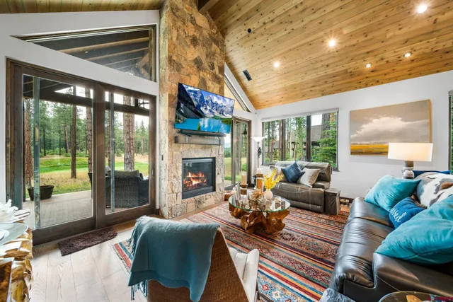 a living room with furniture fireplace and a large window