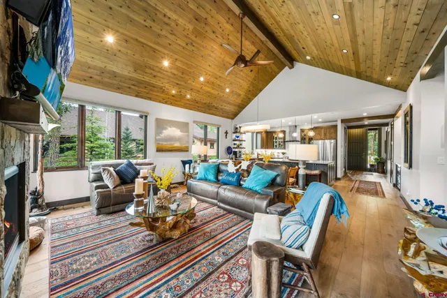 a living room with furniture floor to ceiling window and floor to ceiling window