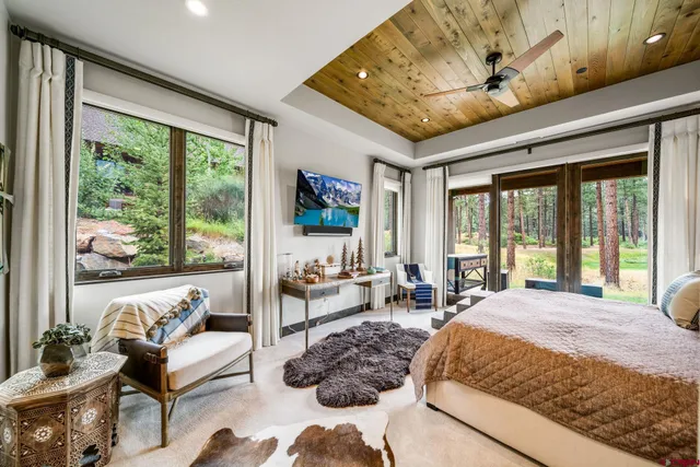 a spacious bedroom with a large bed and a large window