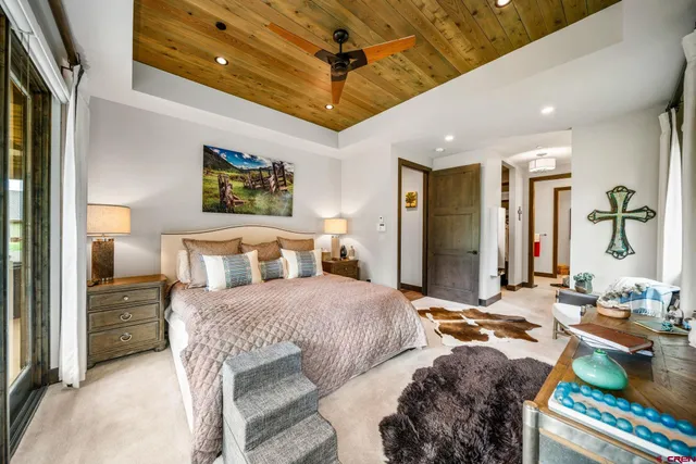 a bedroom with double bed and a dresser