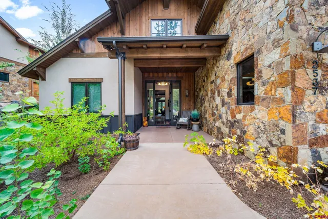 a view of a house with potted plants