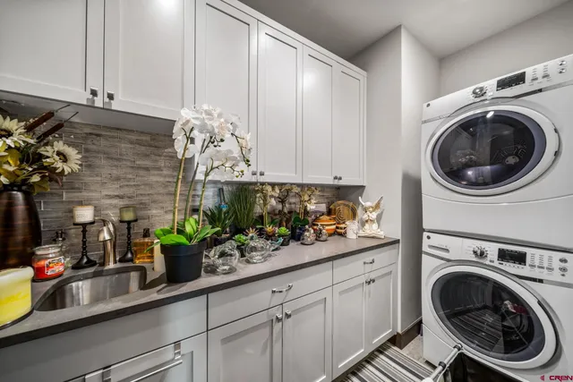 a living room with furniture a ceiling fan and a large window