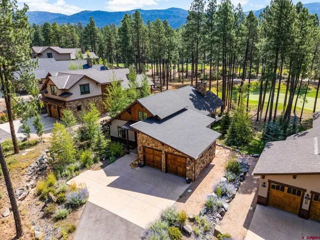 an aerial view of a house with garden space and street view