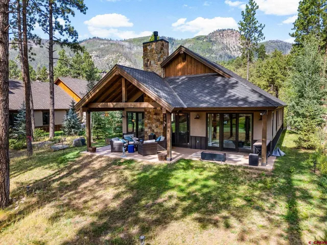 a front view of a house with a yard table and chairs