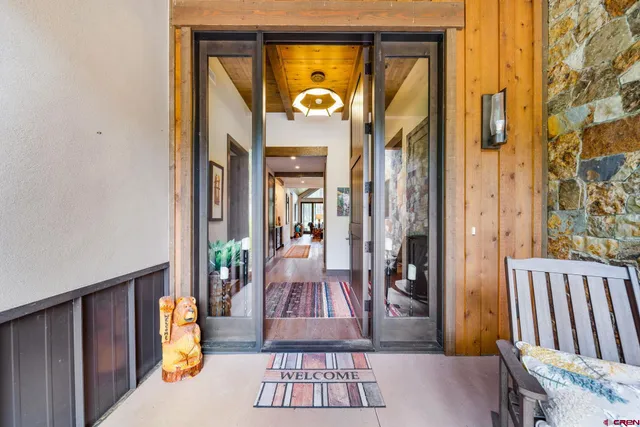 a view of a hallway with wooden floor and windows