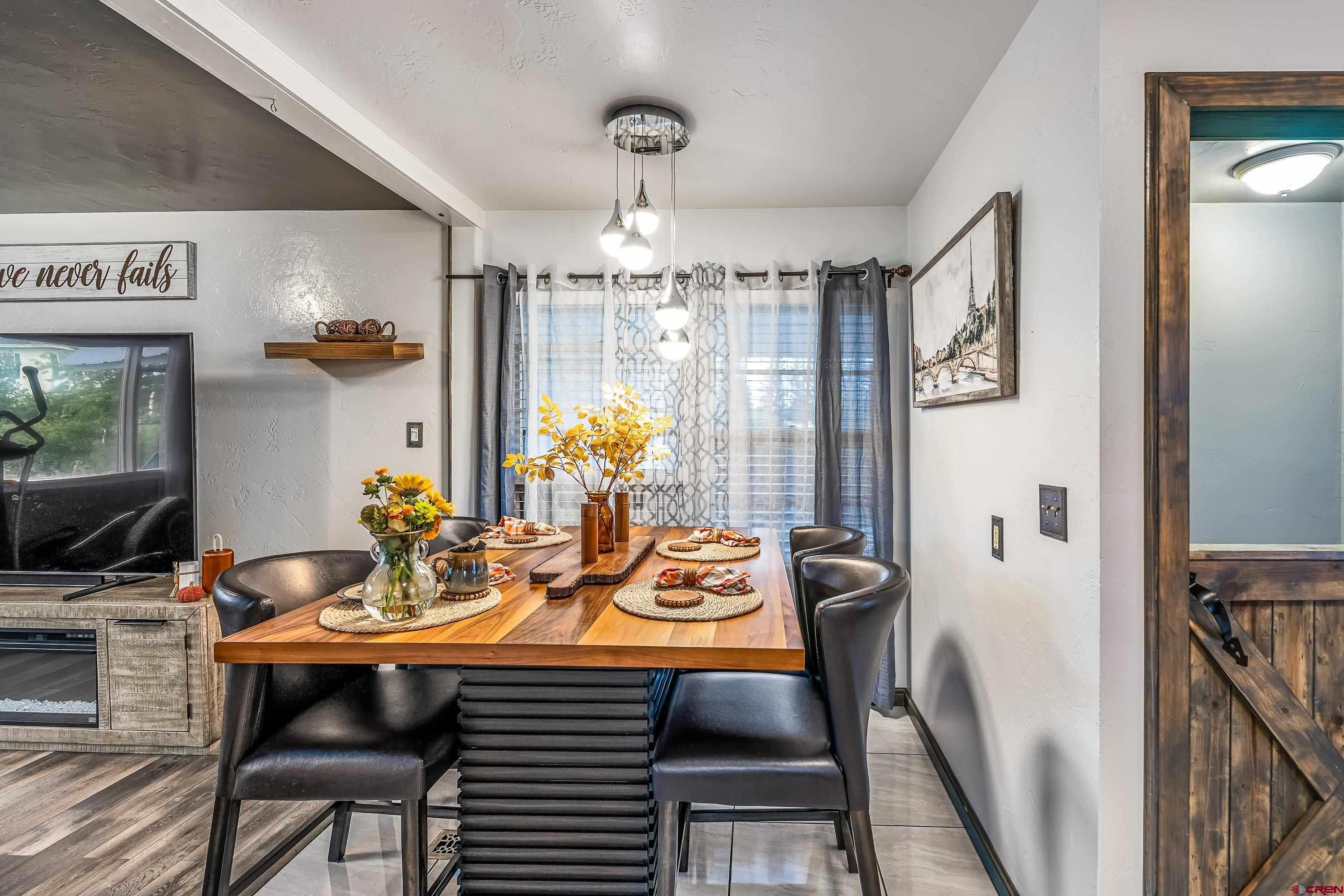 645 Leon Street Delta, CO 81416 - Photo 11 of 28 a view of a dining room with furniture and chandelier
