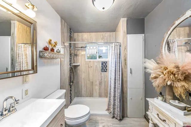 a bathroom with a sink toilet and shower