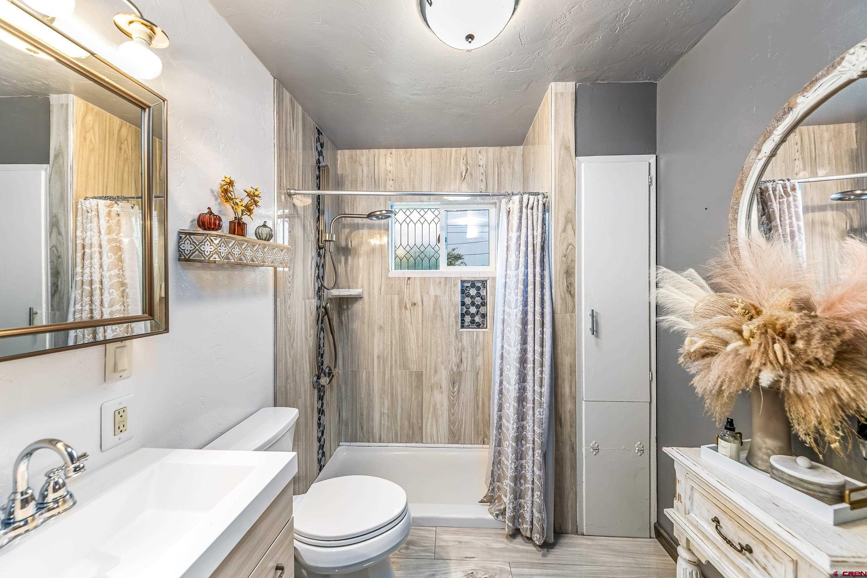 645 Leon Street Delta, CO 81416 - Photo 12 of 28 a bathroom with a sink toilet and shower